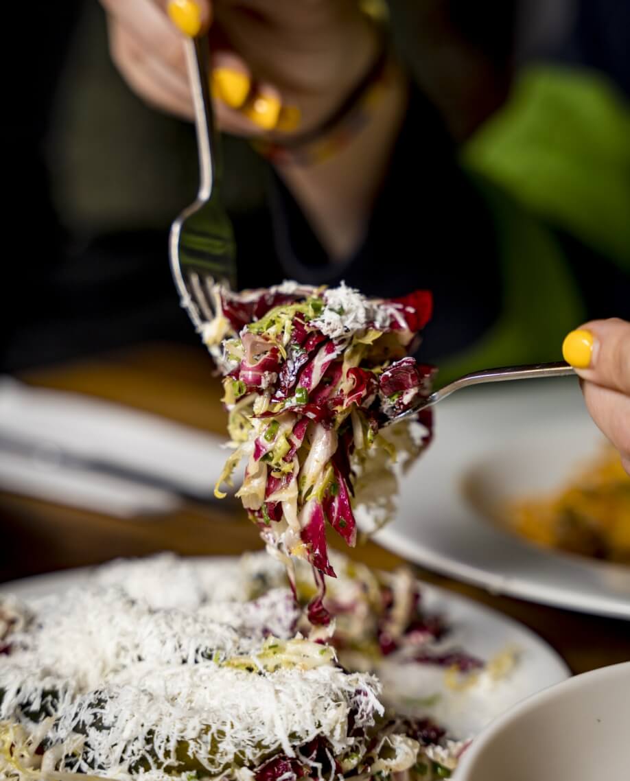 2 forks mixing a salad