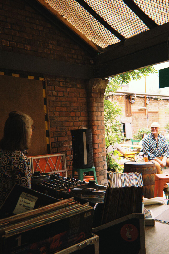 A man enjoying some music in front of the DJ