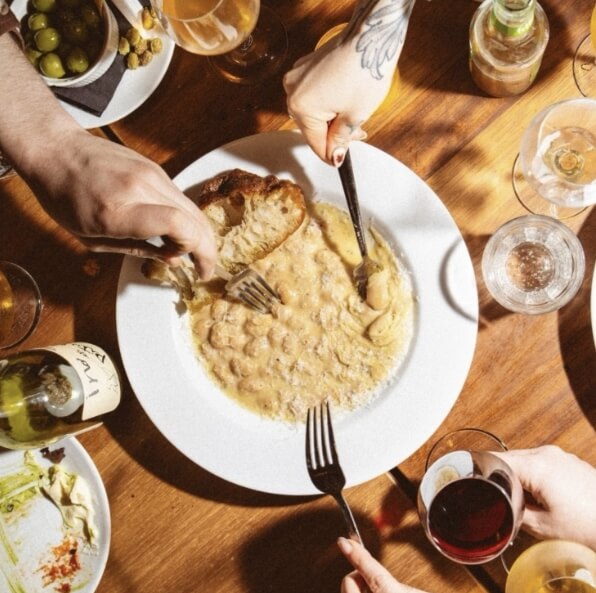 People digging into food at Buyers Club